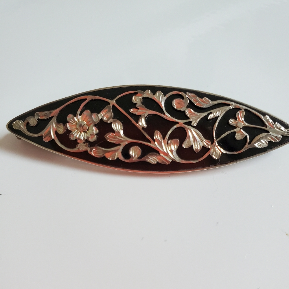 Silver filigree and onyx brooch